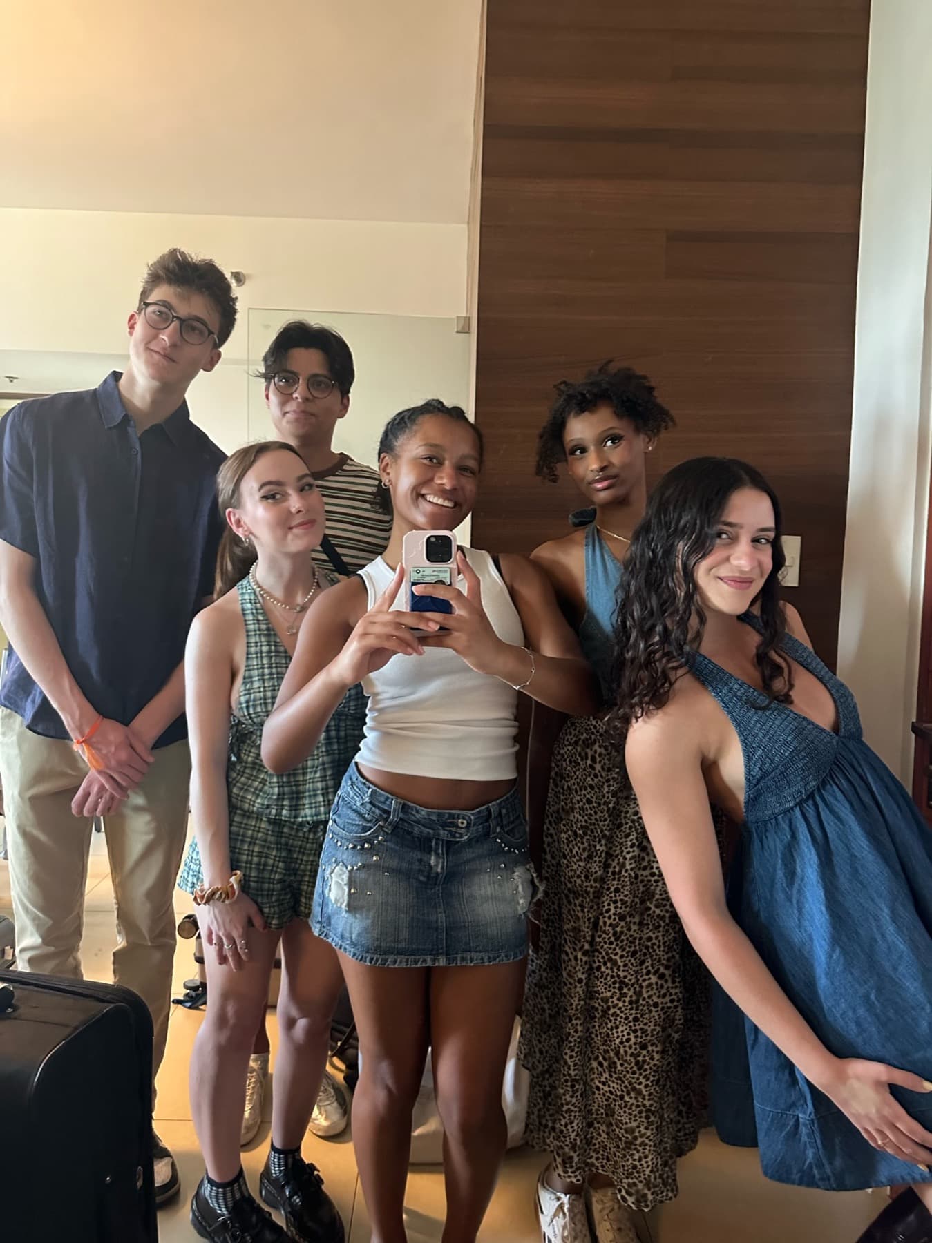 Six MUNTY members posing together for a mirror photograph in a hotel room.